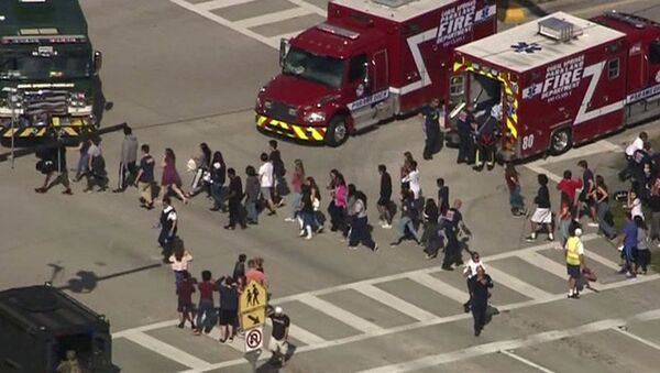 Students are evacuated from Marjory Stoneman Douglas High School during a shooting incident in Parkland, Florida, U.S. February 14, 2018 in a still image from video - Sputnik International