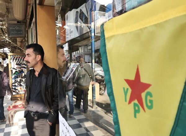 Flag of the Kurdish YPG self-defense forces on the central street of the city of Afrin, Syria Flag of the Kurdish YPG self-defense forces on the central street of the city of Afrin, Syria - Sputnik International