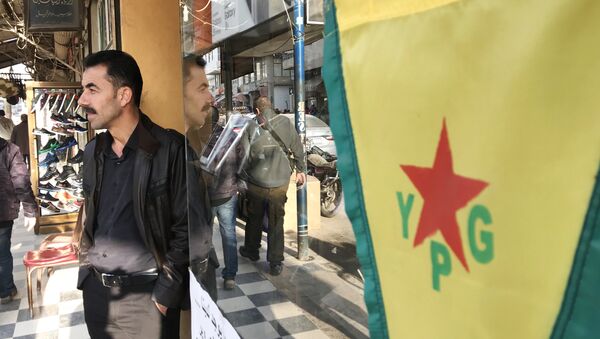 Flag of the Kurdish YPG self-defense forces on the central street of the city of Afrin, Syria - Sputnik International