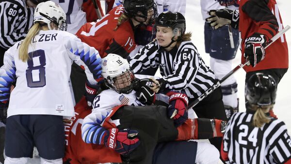 Official Jenni Heikkinen (64), of Finland, tries to separate Kelly Pannek (12), of the United States, and Laura Stacey (7), of Canada, as they scuffle during the third period of a preliminary round during a women's hockey game at the 2018 Winter Olympics in Gangneung, South Korea, Thursday, Feb. 15, 2018 - Sputnik International