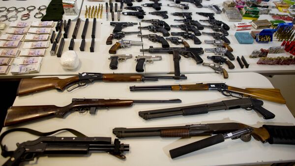 Weapons that were seized during an anti-drug raid, are displayed on a table for a media presentation in Buenos Aires, Argentina, Friday, May 16, 2014 - Sputnik International