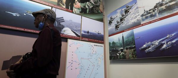 In this July 27, 2017 photo, a man walks by photos showing a map of East China Sea and Chinese military activities at East China Sea on display at the military museum in Beijing In this July 27, 2017 photo, a man walks by photos showing a map of East China Sea and Chinese military activities at East China Sea on display at the military museum in Beijing - Sputnik International