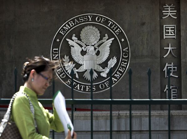 A Chinese woman checks her documents as she walks past the U.S. Embassy in Beijing Friday, May 6, 2011 A Chinese woman checks her documents as she walks past the U.S. Embassy in Beijing Friday, May 6, 2011 - Sputnik International