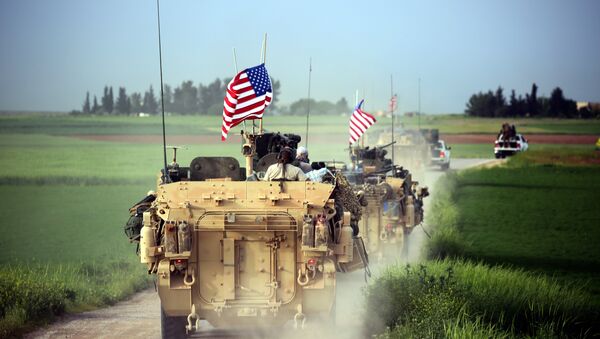 US forces, accompanied by Kurdish People's Protection Units (YPG) fighters, drive their armoured vehicles near the northern Syrian village of Darbasiyah, on the border with Turkey on April 28, 2017 - Sputnik International
