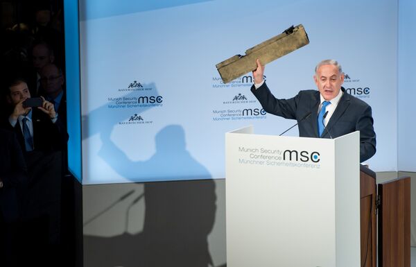 Israeli Prime Minister Benjamin Netanyahu holds up a remnant of what he said was a piece of Iranian drone which was shot down in Israeli airspace during his speech at the Munich Security Conference, Germany February 18, 2018 Israeli Prime Minister Benjamin Netanyahu holds up a remnant of what he said was a piece of Iranian drone which was shot down in Israeli airspace during his speech at the Munich Security Conference, Germany February 18, 2018 - Sputnik International