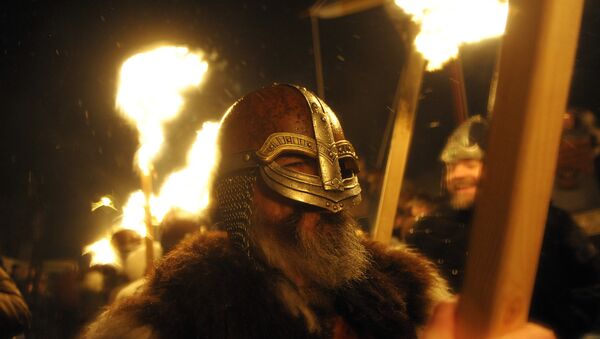 Participants dressed as Vikings carry torches as they march in processing beofre burning their viking galley ship at the culmination of the annual Up Helly Aa festival in Lerwick, Shetland Islands, on January 31, 2017 - Sputnik International