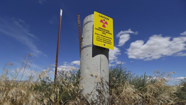 In this photo taken July 11, 2016, a sign warns of radioactive material stored underground on the Hanford Nuclear Reservation near Richland, Wash. - Sputnik International