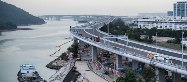 In this picture taken on November 29, 2017, a general view shows a section of the Hong Kong-Zhuhai-Macau Bridge (HKZMB) (C) that runs alongside the international airport (R) in Hong Kong - Sputnik International