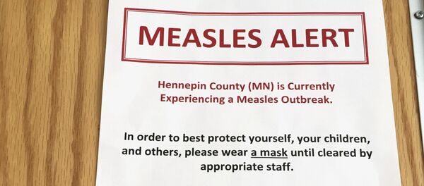 (File) In this Tuesday, May 2, 2017 photo, a sign at the specialty clinic at Children's Minnesota in Minneapolis, alerts patients to a measles outbreak in the area (File) In this Tuesday, May 2, 2017 photo, a sign at the specialty clinic at Children's Minnesota in Minneapolis, alerts patients to a measles outbreak in the area - Sputnik International