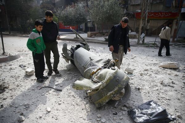People inspect missile remains in the besieged town of Douma, in eastern Ghouta, in Damascus, Syria, February 23, 2018 People inspect missile remains in the besieged town of Douma, in eastern Ghouta, in Damascus, Syria, February 23, 2018 - Sputnik International