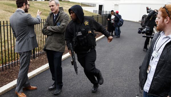 A Secret Service officer rushes past reporters after a vehicle rammed into a security barrier near the White House, Friday, Feb. 23, 2018, in Washington. - Sputnik International