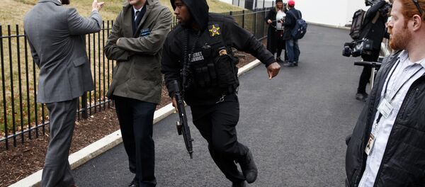 A Secret Service officer rushes past reporters after a vehicle rammed into a security barrier near the White House, Friday, Feb. 23, 2018, in Washington. - Sputnik International