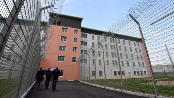 In this file photo taken on October 14, 2015 prison guards walk in a yard during a press visit in the then new prison in Valence, southeastern France - Sputnik International