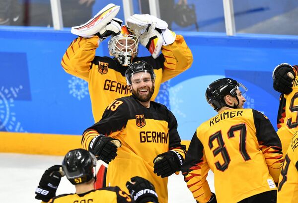 Germany's hockey players celebrate their victory in the semifinals between the Canada and Germany national teams in the men’s ice hockey tournament, at the XXIII Olympic Winter Games Germany's hockey players celebrate their victory in the semifinals between the Canada and Germany national teams in the men’s ice hockey tournament, at the XXIII Olympic Winter Games - Sputnik International