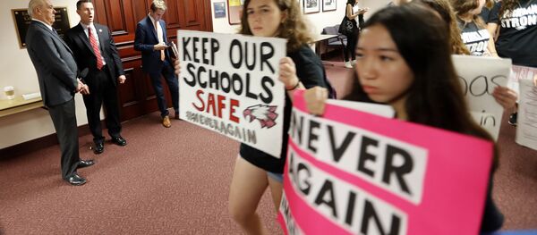 Student survivors from Marjory Stoneman Douglas High School, where 17 students and faculty were killed in a mass shooting on Wednesday, walk past the house legislative committee room, to talk to legislators at the state Capitol, regarding gun control legislation, in Tallahassee, Fla., Wednesday, Feb. 21, 2018 - Sputnik International