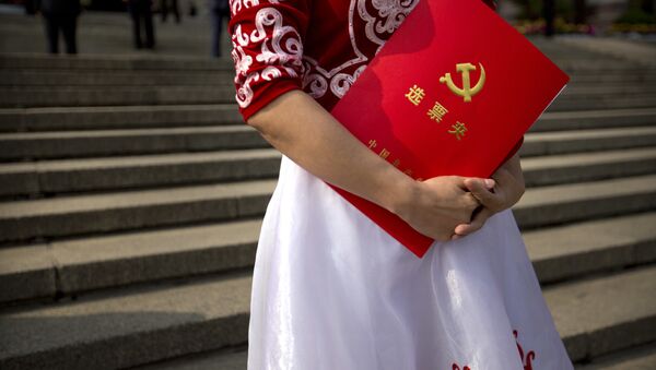 A delegate holds her ballot folder after the closing ceremony of China's 19th Party Congress at the Great Hall of the People in Beijing, Tuesday, Oct. 24, 2017 - Sputnik International