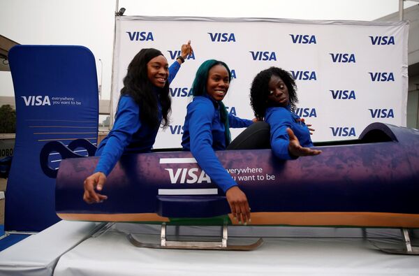 Nigerian Women's Bobsled Team Ngozi Onwumere, Akuoma Omeoga and Seun Adigun gesture in a bobsled upon their arrival in Lagos, Nigeria, as part of preparations ahead of the 2018 Pyeongchang Winter Olympic Games, February 1, 2018 - Sputnik International