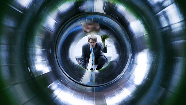 A man looks into a tube representing a natural gas pipeline at the booth of Nord Stream at the Hanover industrial fair in Hanover, Germany (File) - Sputnik International