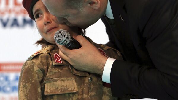 FILE - In this Saturday, Feb. 24, 2018 file photo, Turkish President Recep Tayyip Erdogan kisses Amine Tiras, a young girl in military uniform as he speaks to his ruling party members, in Kahramanmaras, Turkey - Sputnik International