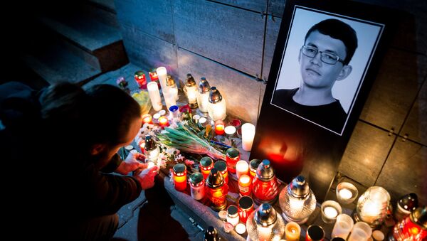 A man lits a candle in front of the Aktuality newsroom, the employer of the murdered investigative journalist Jan Kuciak, on February 26, 2018 in Bratislava - Sputnik International