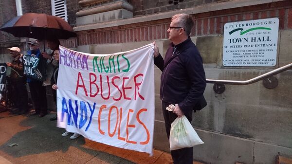 Protest at Peterborough Town Hall against Andy Coles, banner made by Jessica © Sack Andy Coles 2017 Protest at Peterborough Town Hall against Andy Coles, banner made by Jessica © Sack Andy Coles 2017 - Sputnik International