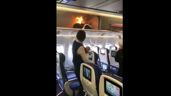 Carry-on bag inside overhead compartment on China Southern Airlines flight goes up in flames - Sputnik International