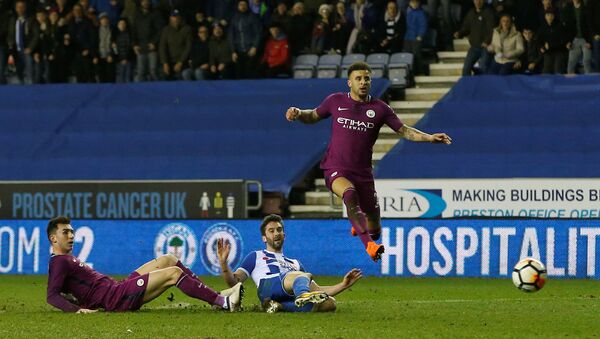 Soccer Football - FA Cup Fifth Round - Wigan Athletic vs Manchester City - DW Stadium, Wigan, Britain - February 19, 2018 Wigan Athletic’s Will Grigg scores their first goal as Manchester City's Kyle Walker and Aymeric Laporte - Sputnik International
