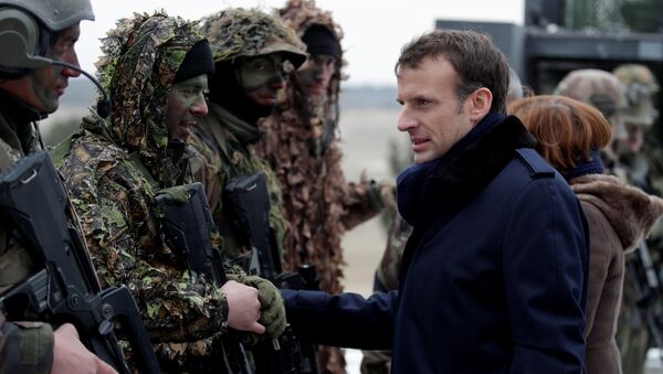 French President Emmanuel Macron speaks with soldiers wearing camouflage as he attends a military exercise at the military camp of Suippes, near Reims, France, March 1, 2018 - Sputnik International