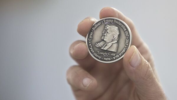 Head of the Mikdash Educational Center, Rabbi Mordecahi Persoss, holds a coin they minted bearing President Donald Trump's image to honor his recognition of Jerusalem as Israel's capital, in Tel Aviv, Israel, Wednesday, Feb. 28, 2018. - Sputnik International