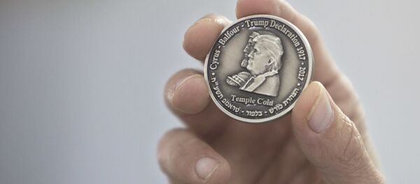 Head of the Mikdash Educational Center, Rabbi Mordecahi Persoss, holds a coin they minted bearing President Donald Trump's image to honor his recognition of Jerusalem as Israel's capital, in Tel Aviv, Israel, Wednesday, Feb. 28, 2018. Head of the Mikdash Educational Center, Rabbi Mordecahi Persoss, holds a coin they minted bearing President Donald Trump's image to honor his recognition of Jerusalem as Israel's capital, in Tel Aviv, Israel, Wednesday, Feb. 28, 2018. - Sputnik International