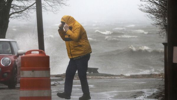 A pedestrian walks near the coastline Friday, March 2, 2018, in Newburyport, Mass. as a major nor'easter pounds the East Coast, packing heavy rain, intermittent snow and strong winds. - Sputnik International