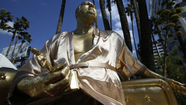 A golden statue of a bathrobe-clad Harvey Weinstein, seated almost regally atop a couch holding a fake Oscar Statuette, takes up temporary sidewalk residence four days before the Oscars on Hollywood Blvd. in Los Angeles Thursday, March 1, 2018. - Sputnik International