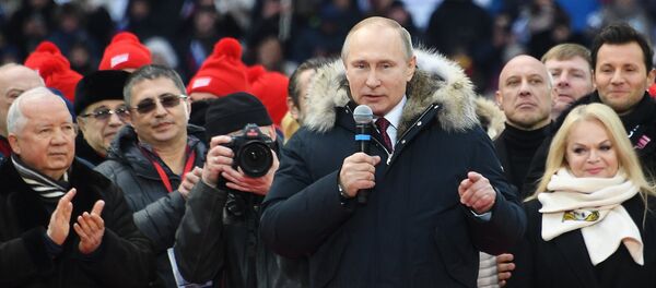 Russian President Putin delivers a speech during a rally to support his bid in the upcoming presidential election at Luzhniki Stadium in Moscow - Sputnik International
