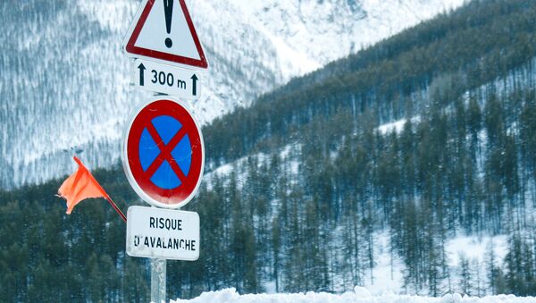 Road signs are pictured on a snow-covered road in Saint-Pancrace as winter weather bringing snow and freezing temperatures continues in France, March 2, 2018. The sign reads, Avalanche risk - Sputnik International