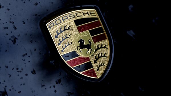 The logo of German car manufacturer Porsche is rain covered at a car in Munich, Germany, Friday, July 28, 2017 - Sputnik International