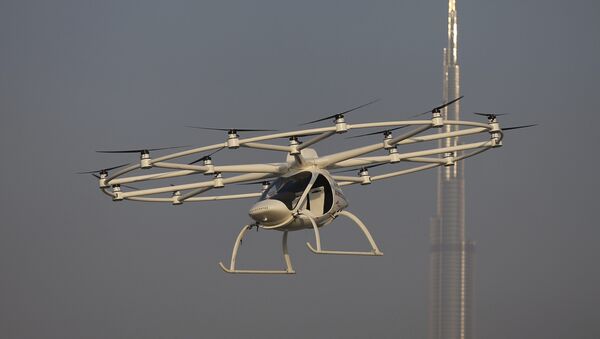 In this Sept. 26, 2017 photo, a Volocopter prototype flies in front of the Burj Khalifa, the world's tallest tower, during a test flight in Dubai, United Arab Emirates - Sputnik International