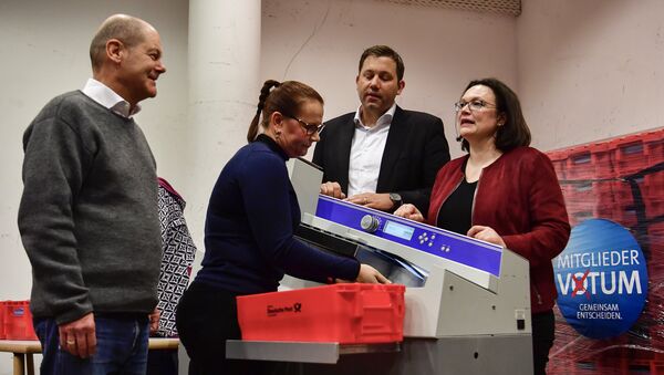 Acting Chairman of the Social Democratic Party (SPD) Olaf Scholz (L), Secretary-General of the Social Democratic Party (SPD) Lars Klingbeil (2nd R) and German Labour and Social Minister Andrea Nahles (R) react as they look at an envelope opening machine prior to the counting of the ballots, at the headquarters of Germany's social democratic SPD party in Berlin on March 3, 2018, as SPD members voted on whether or not to join a new coalition government with German Chancellor Angela Merkel's conservatives - Sputnik International