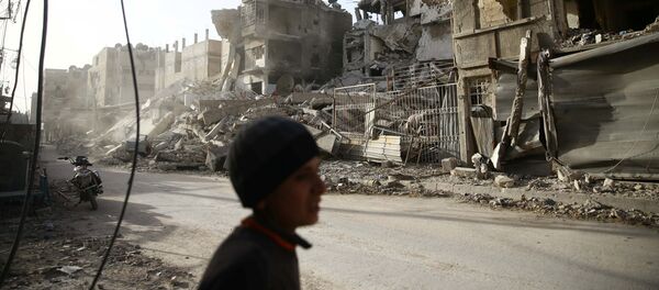 A boy walks near damaged buildings in the besieged town of Douma in eastern Ghouta in Damascus, Syria, March 1, 2018 A boy walks near damaged buildings in the besieged town of Douma in eastern Ghouta in Damascus, Syria, March 1, 2018 - Sputnik International