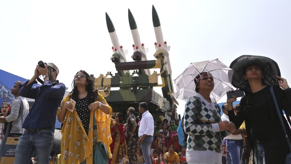 Spectators stand next to the models of Akash, surface-to-air missile, as they watch fighter aircraft perform on the fourth day of Aero India 2017 at Yelahanka air base in Bangalore, India, Friday, Feb. 17, 2017 - Sputnik International