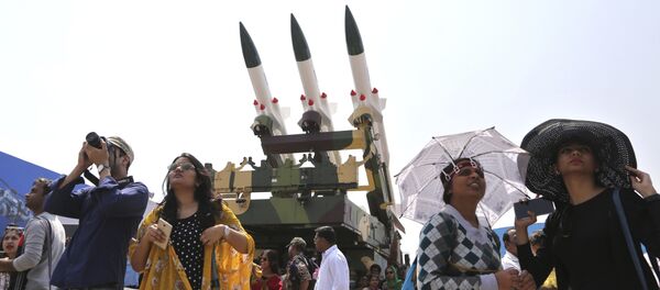 Spectators stand next to the models of Akash, surface-to-air missile, as they watch fighter aircraft perform on the fourth day of Aero India 2017 at Yelahanka air base in Bangalore, India, Friday, Feb. 17, 2017 - Sputnik International