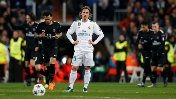 Luka Modric looks dejected as Paris St Germain players celebrate a goal but he could face jail in his native Croatia - Sputnik International
