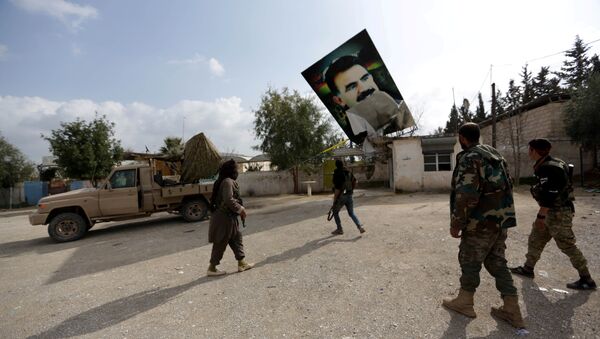 Turkish-backed Free Syrian Army fighters remove a picture of Kurdistan Workers Party (PKK) leader Abdullah Ocalan in Kafr Jana village north of Afrin, Syria March 7, 2018 - Sputnik International