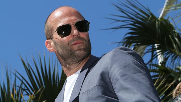 British actor Jason Statham poses on a tank as he arrives for a photocall for the film The Expendables 3 at the 67th edition of the Cannes Film Festival in Cannes, southern France, on May 18, 2014 - Sputnik International