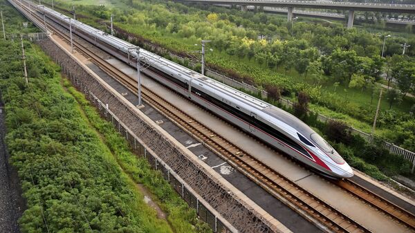 In this Aug. 21, 2017 photo released by China's Xinhua News Agency, a Fuxing bullet train, China's latest high-speed train, arrives at a train station in northern China's Tianjin Municipality - Sputnik International