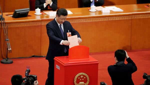 Chinese President Xi Jinping drops his ballot, during a vote on a constitutional amendment lifting presidential term limits, at the third plenary session of the National People's Congress (NPC) at the Great Hall of the People in Beijing, China March 11, 2018 - Sputnik International