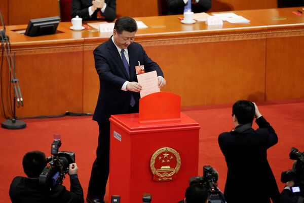 Chinese President Xi Jinping drops his ballot, during a vote on a constitutional amendment lifting presidential term limits, at the third plenary session of the National People's Congress (NPC) at the Great Hall of the People in Beijing, China March 11, 2018 - Sputnik International