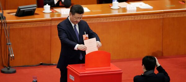 Chinese President Xi Jinping drops his ballot, during a vote on a constitutional amendment lifting presidential term limits, at the third plenary session of the National People's Congress (NPC) at the Great Hall of the People in Beijing, China March 11, 2018 Chinese President Xi Jinping drops his ballot, during a vote on a constitutional amendment lifting presidential term limits, at the third plenary session of the National People's Congress (NPC) at the Great Hall of the People in Beijing, China March 11, 2018 - Sputnik International