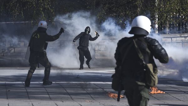 A masked protester throws a molotov cocktail at riot policemen during clashes outside the University of Thessaloniki campus, in Thessaloniki, Greece Saturday March 10, 2018 - Sputnik International