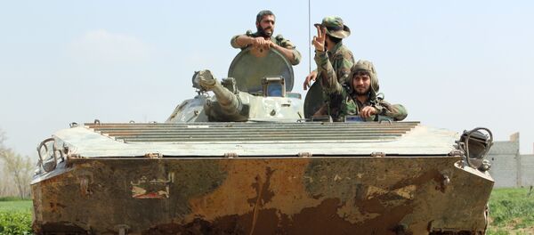 Syrian regime forces sit inside a tank in the town of Aftris, west of the rebel-held town of Saqba, in the besieged Eastern Ghouta region on the outskirts of the capital Damascus, on March 10, 2018 Syrian regime forces sit inside a tank in the town of Aftris, west of the rebel-held town of Saqba, in the besieged Eastern Ghouta region on the outskirts of the capital Damascus, on March 10, 2018 - Sputnik International