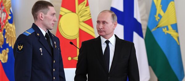President Vladimir Putin and Gefr. Denis Portnyagin, left, at a ceremony to present state awards to the Russian service personnel who took part in the counter-terrorism operation in the Syrian Arab Republic. File photo - Sputnik International